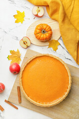 Composition with tasty pumpkin pie on light background