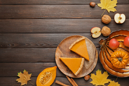 Composition with tasty cut pumpkin pie on wooden background