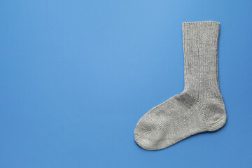 Warm sock on color background