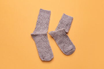 Warm socks on color background