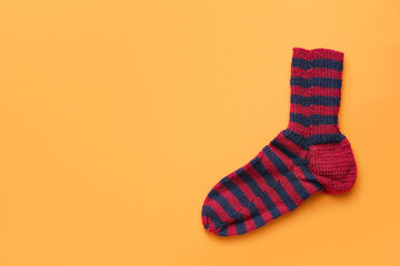 Warm sock on color background