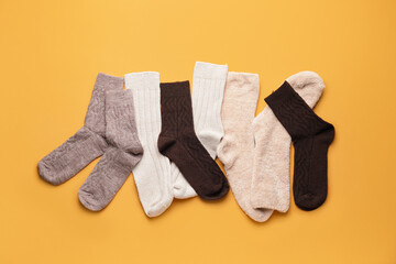 Warm socks on color background