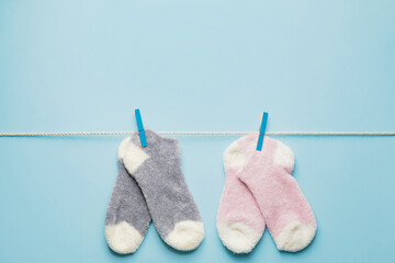 Rope with warm socks on color background