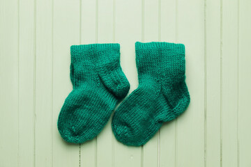 Warm socks on color wooden background