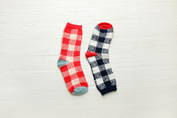 Warm socks on white wooden background
