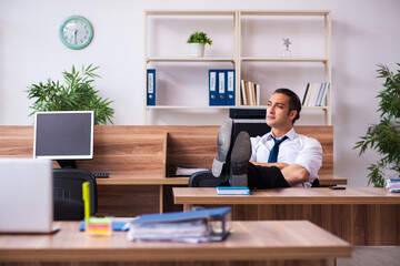 Young male employee working in the office