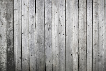 Wooden weathered wall or fence made of unpainted boards