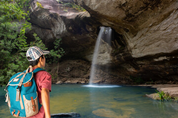Young man traveler with a backpack at saeng chan waterfall.
