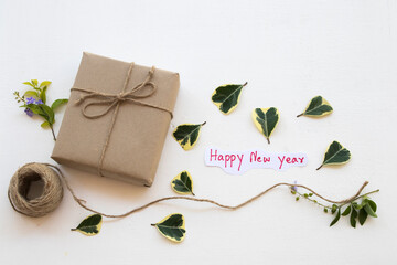 Fototapeta na wymiar gift box with happy new year message card handwriting for special in new year festival day arrangement on background white