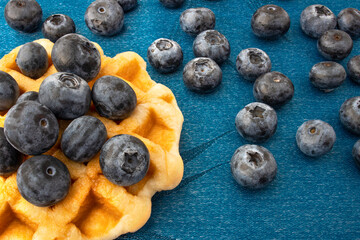 Waffle and bluebertries on blue silk cloth.