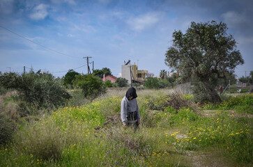 Boy walk alone on Spring green fieds