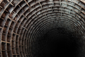 Round dark abandoned Elevator shaft with rusty metal cladding