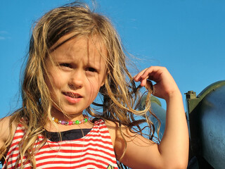 Face  of the little girl against the blue sky