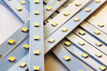 Pile of Led smd screen strip on white background. Diode strip. LED lights tape pattern. Selective focus, shallow depth of field.