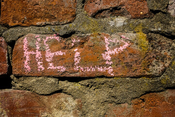 red brick wall with the word - HELP.