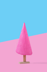 Creative concept with pink ice cream cone as Christmas tree. Christmas and holiday season concept