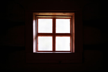 Fototapeta na wymiar The window of an old wooden house. Textured window silhouette.