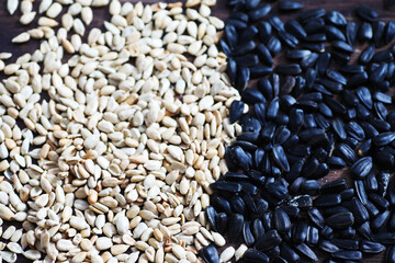 Sunflower seeds in a wooden spoon on a wooden rustic background.