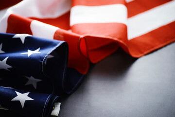 Flapping flag USA with wave. American flag for Memorial Day or 4th of July. Closeup of American flag dark background