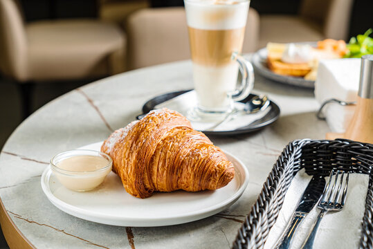 croissant and cappuccino in the cafe