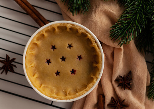 christmas cherries pie with cinnamon on a rustic wood background  from adove
