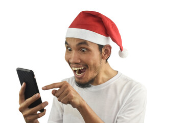 Asian man holding mobile phone happy merry Christmas so excited in shopping online