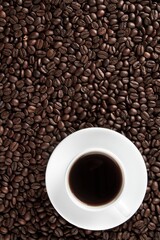 Cup of coffee surrounded by coffee beans