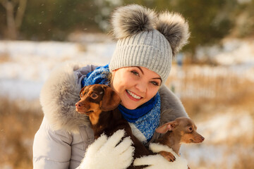 Woman playing with dogs during winter