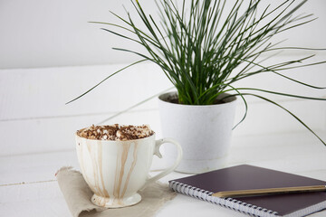 drink with marshmallows in a mug with drips on a light wooden surface