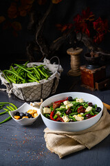 Spicy green bean salad with olives, feta cheese and dried tomatoes