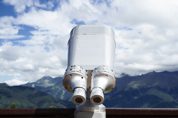 Binoculars on the viewport in the mountains. Look into the distance, beyond the horizon.