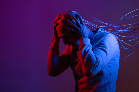 man with electrodes in his head screams in horror, a polygraph lie detector test,