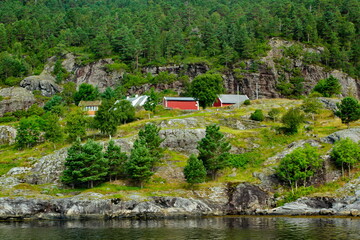 Fototapeta na wymiar Scenic view of cottages in the woods on the shores of Osterfjord near Bergen, Norway
