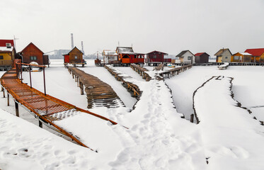 View of the famous floating village at wintertime. Frozen lake, snowy landscape. Bokod,Hungary.