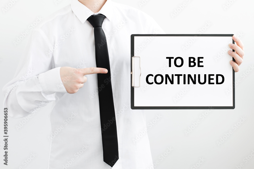 Aufkleber a businessman holds a folder with documents, the text on the folder is - to be continued. business c