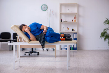 Young male doctor radiologist being unhappy after night shift