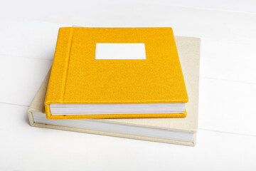 Elegant yellow and beige books with linen cover and metal nameplate. Wedding photobook. Family...