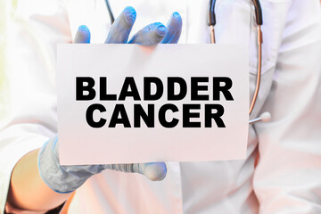 The doctor's blue - gloved hands show the word BLADDER CANCER - . a gloved hand on a white background. Medical concept. the medicine