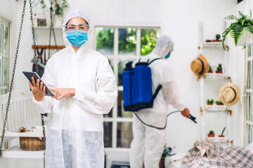 Professional teams for disinfection worker in protective mask and white suit disinfectant spray cleaning virus for help service kill coronavirus at customer home