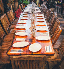 Large table prepared for celebration dinner. Wedding or Christmas reception.