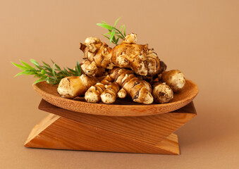 jerusalem artichoke on brown background. Topinambur isolat