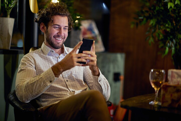 An employee spending New Year's eve in a relaxed atmosphere at workplace alone with a phone. Job, New Year, celebration