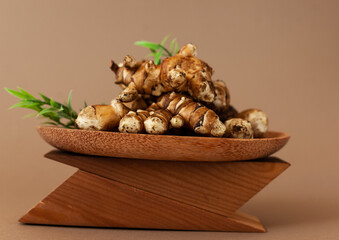jerusalem artichoke on brown background. Topinambur isolat