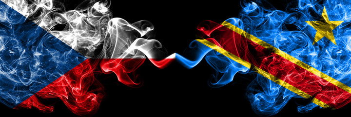 Czech Republic, Czech vs Democratic Republic of the Congo smoky mystic flags placed side by side. Thick colored silky abstract smoke flags.