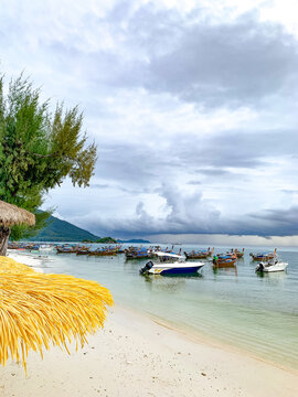 Speed boats and traditional long tail boats parking on shore in Lipe Island, Sutun, Thailand.