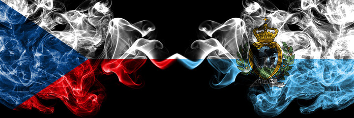 Czech Republic, Czech vs San Marino smoky mystic flags placed side by side. Thick colored silky abstract smoke flags.