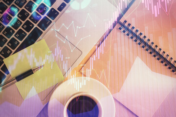 Stock market graph and top view computer on the table background. Double exposure. Concept of financial education.