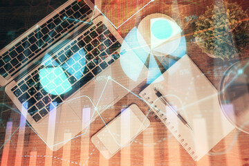 Financial market graph and top view computer on the desktop background. Double exposure. Investment concept.