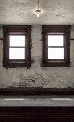 Bare light bulb in an empty grunge room in vertical orientation.