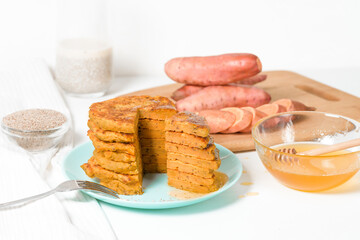 homemade autumn stack vegetarian pancakes with sweet potatoes and Chia seeds, low-calorie Breakfast, taking care of the body. watered with honey on a light background